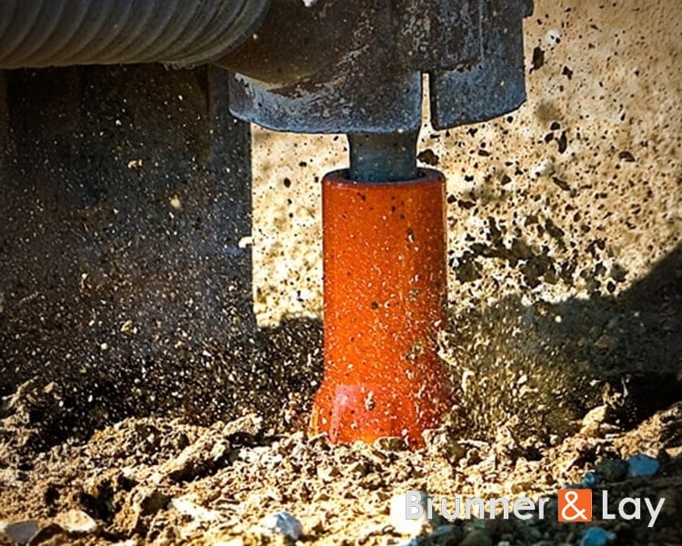 Earth buster machine vibrating soil at a construction site for excavation