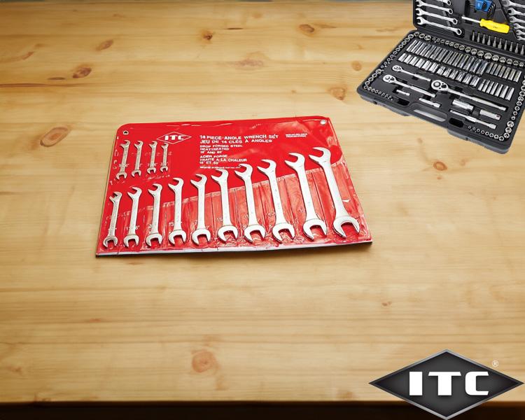 A set of wrenches organized on a red holder laid on a wooden table, with a box of various tools slightly blurred in the background, displaying the itc logo.