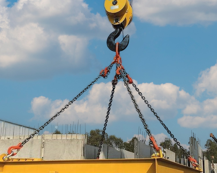 Chaîne de levage robuste fixée à un crochet de grue avec points d’ancrage bien définis sur une grande structure en acier