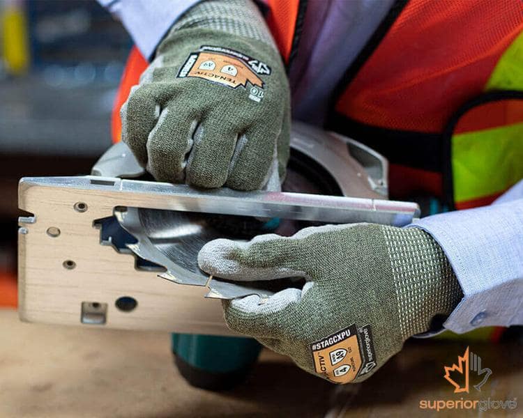 Close-up of a Superior Glove cut-resistant glove being worn by a worker, highlighting its durability and protection features.